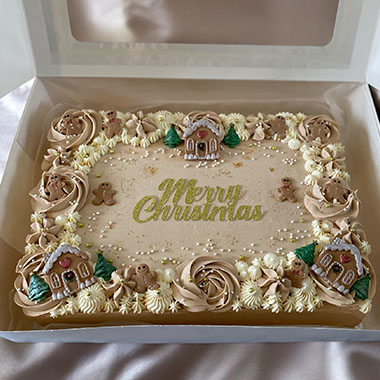 Decorative Christmas cake in a box, featuring the text