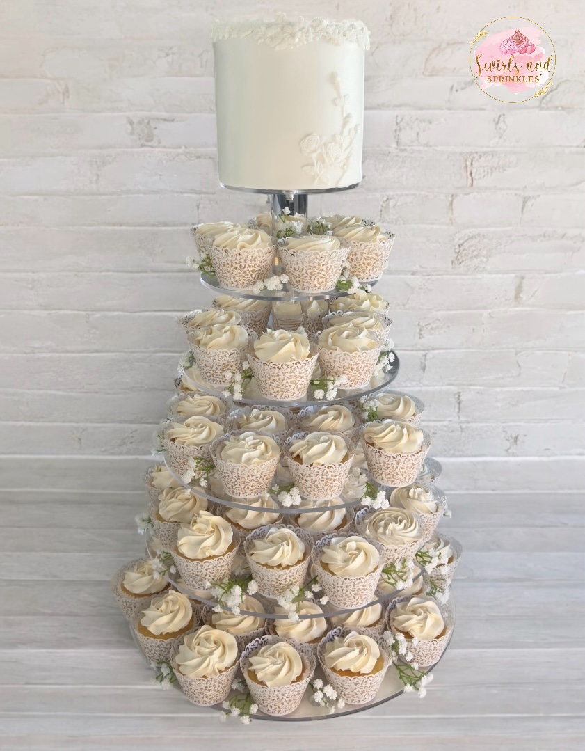 Beautiful cupcake tower with cutting cake on top